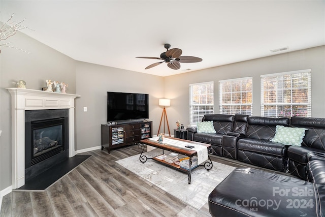 living room with ceiling fan and dark wood-type flooring