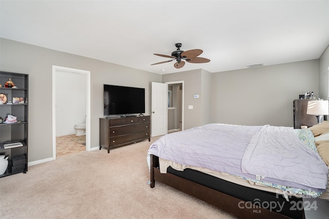 carpeted bedroom featuring ensuite bathroom and ceiling fan