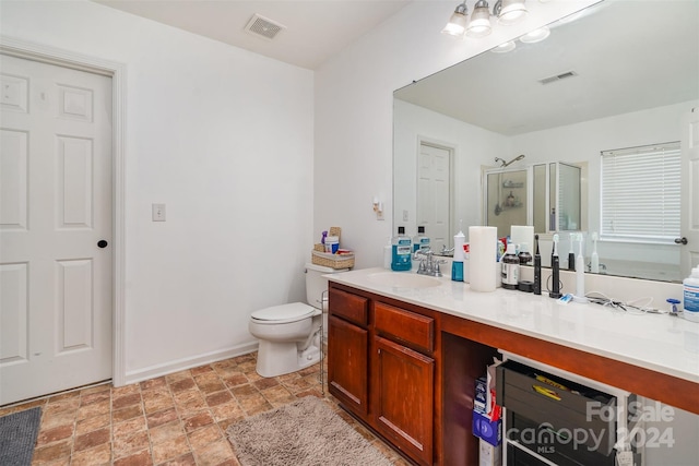 bathroom with vanity, toilet, and walk in shower