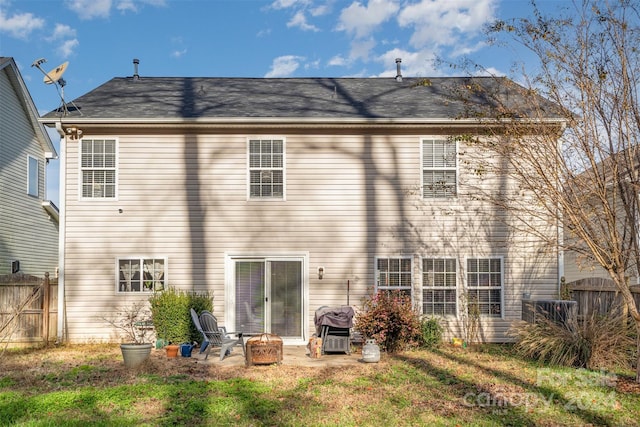 back of property featuring a patio area and a yard