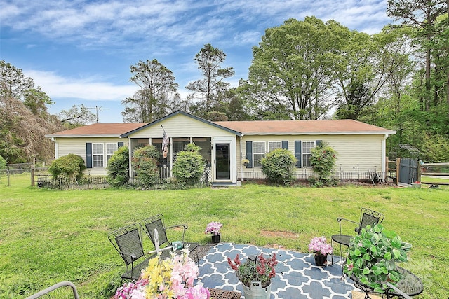 ranch-style house featuring a front yard and fence