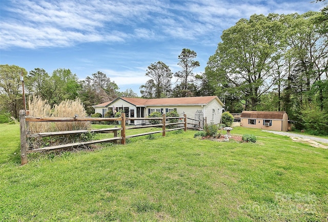 exterior space with an outbuilding, a storage shed, and fence