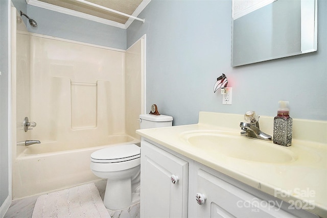 full bath featuring toilet, washtub / shower combination, crown molding, and vanity