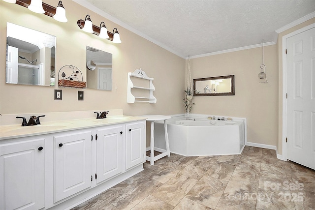 bathroom with a garden tub, a textured ceiling, ornamental molding, and a sink