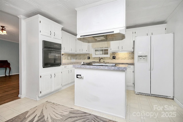 kitchen featuring light floors, oven, white cabinetry, light countertops, and white fridge with ice dispenser