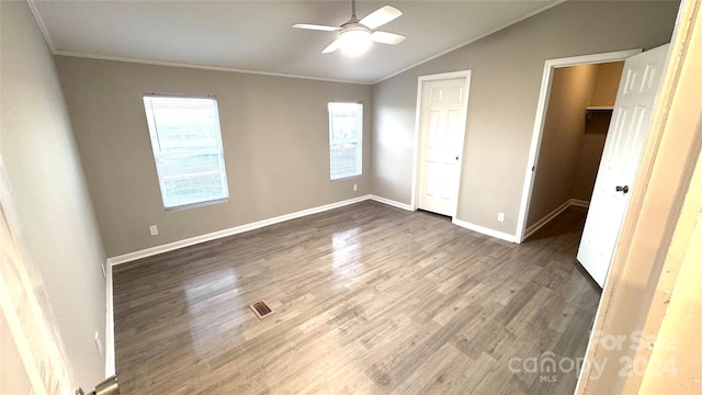 unfurnished bedroom with dark hardwood / wood-style floors, crown molding, ceiling fan, and lofted ceiling