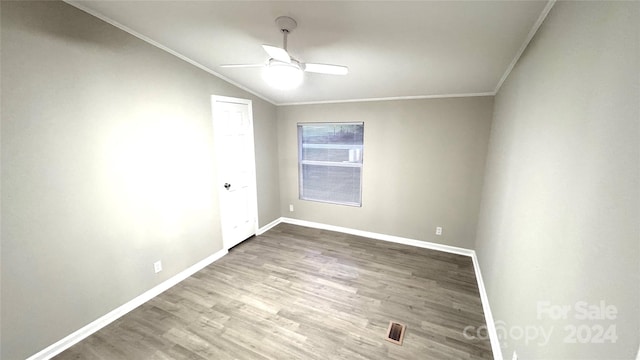 unfurnished room featuring ceiling fan, wood-type flooring, crown molding, and vaulted ceiling