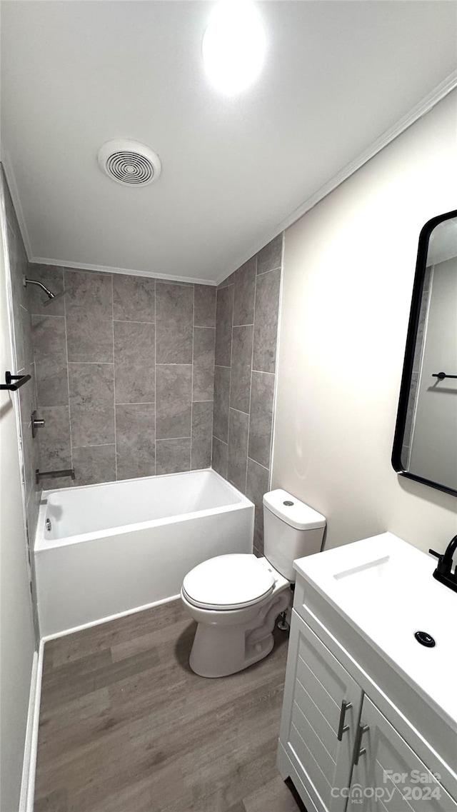 full bathroom featuring wood-type flooring, vanity, toilet, and tiled shower / bath