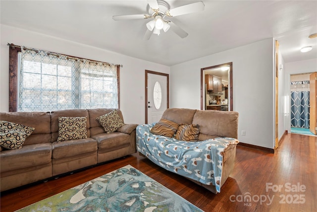 living room with ceiling fan and dark hardwood / wood-style floors