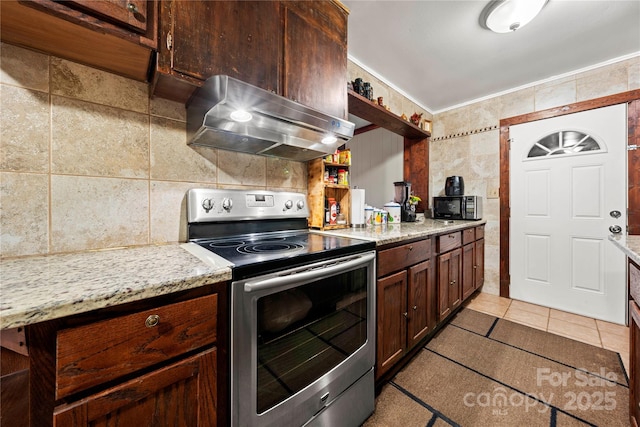 kitchen featuring light tile patterned floors, stainless steel electric range oven, dark brown cabinets, light stone countertops, and exhaust hood