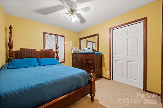 bedroom with ceiling fan and light carpet