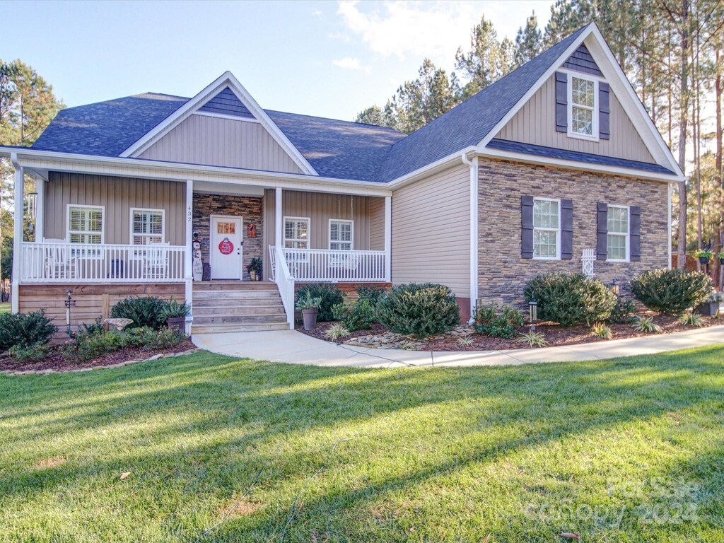 view of front of house with a porch and a front lawn