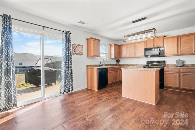 kitchen with hanging light fixtures, dark hardwood / wood-style flooring, plenty of natural light, and black appliances