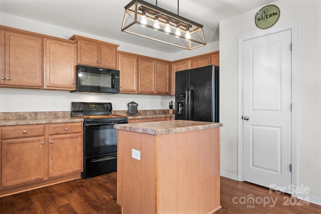 kitchen featuring pendant lighting, a kitchen island, black appliances, and dark hardwood / wood-style floors