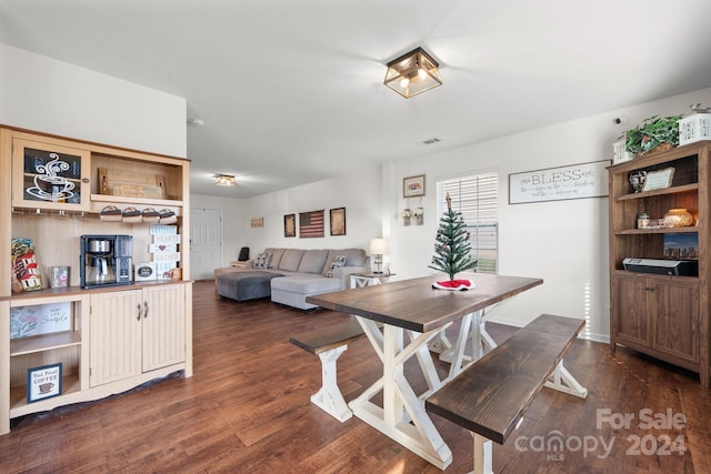 dining space featuring dark wood-type flooring