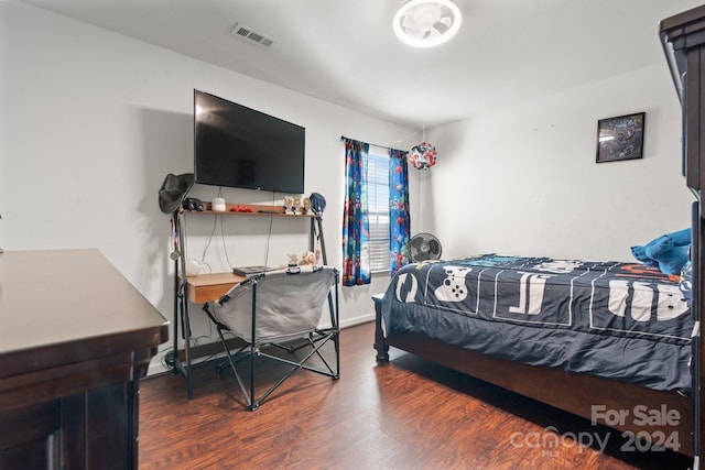 bedroom with dark hardwood / wood-style flooring