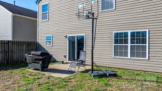 rear view of house featuring a patio area and a yard