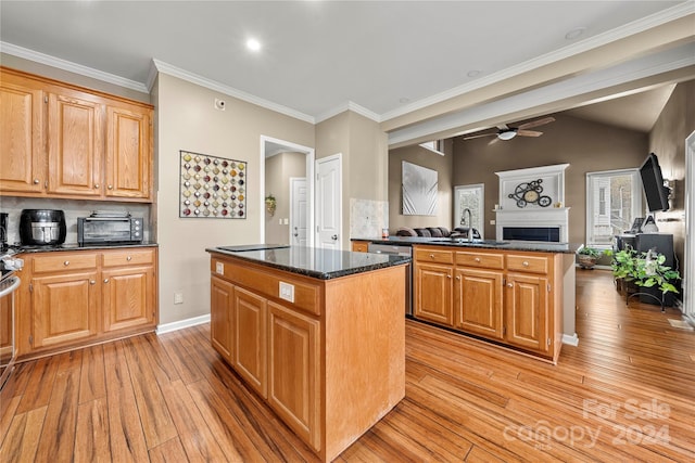 kitchen with a center island, sink, light hardwood / wood-style flooring, appliances with stainless steel finishes, and tasteful backsplash