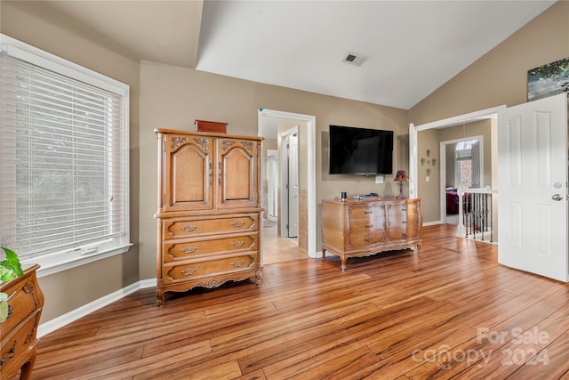 bedroom with lofted ceiling and light hardwood / wood-style flooring