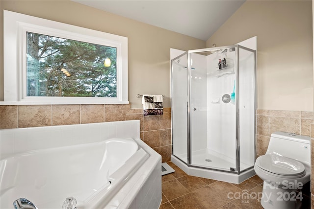 bathroom featuring tile patterned flooring, separate shower and tub, toilet, and lofted ceiling