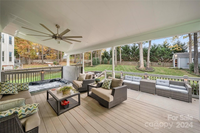 wooden terrace featuring ceiling fan, a yard, and an outdoor hangout area