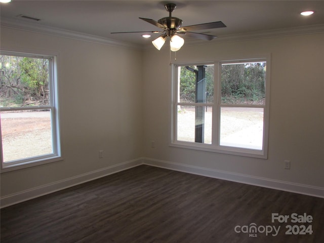 unfurnished room with crown molding, ceiling fan, and dark wood-type flooring