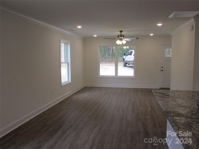 unfurnished living room featuring ceiling fan, ornamental molding, and dark wood-type flooring