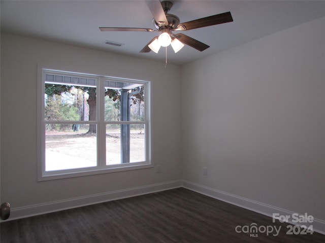 unfurnished room with ceiling fan and dark wood-type flooring