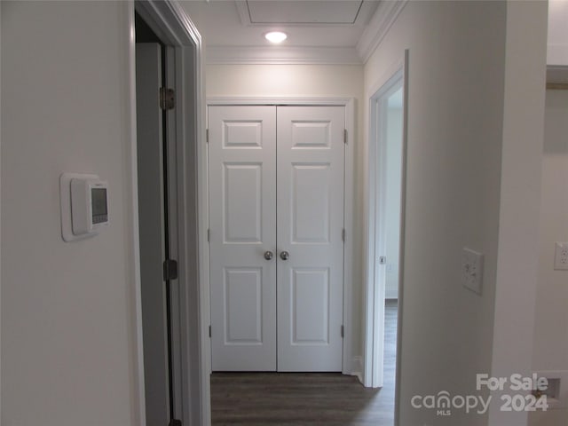 hallway with dark hardwood / wood-style flooring and ornamental molding