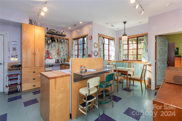 kitchen featuring decorative light fixtures and butcher block countertops