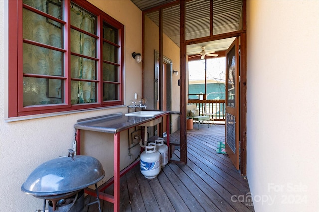 wooden deck with covered porch and sink