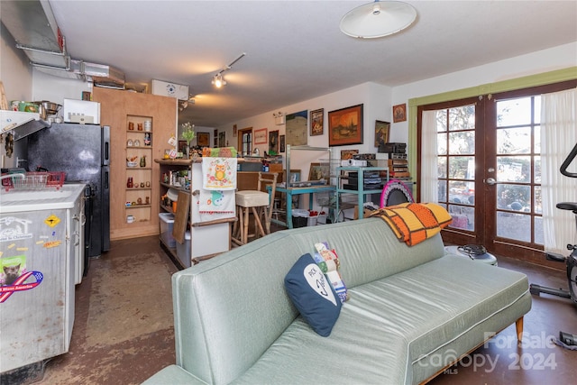 living room with concrete floors and french doors