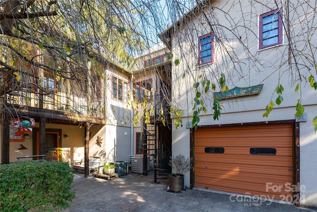 view of front of property featuring central AC and a garage