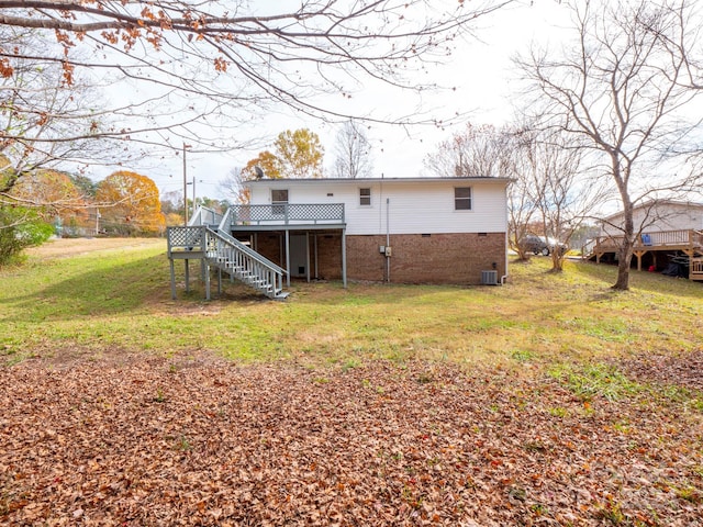 back of house featuring central air condition unit, a yard, and a deck