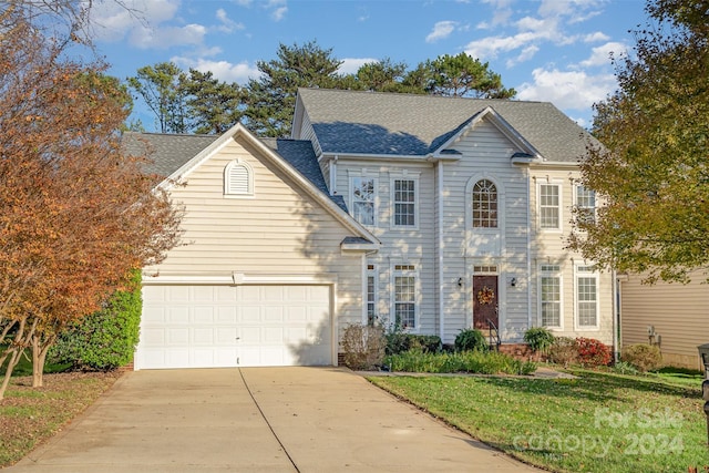 view of front of house with a front yard and a garage