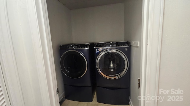 washroom with separate washer and dryer and laundry area