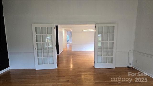 empty room with french doors and wood finished floors