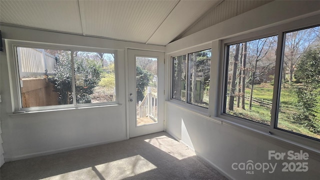 unfurnished sunroom featuring vaulted ceiling