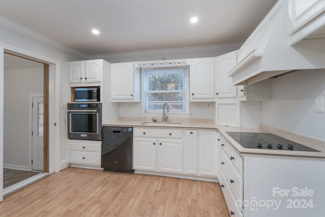 kitchen featuring crown molding, sink, black appliances, light hardwood / wood-style flooring, and white cabinets