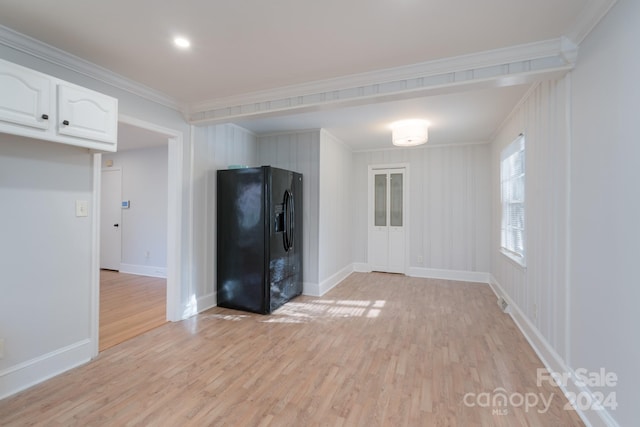 empty room with light wood-type flooring and ornamental molding