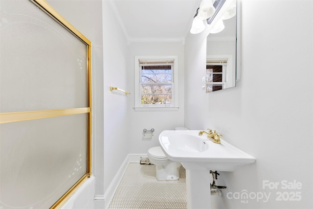 bathroom featuring crown molding, combined bath / shower with glass door, tile patterned floors, and toilet