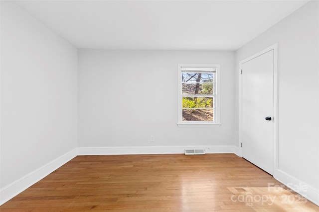 unfurnished room with light hardwood / wood-style flooring