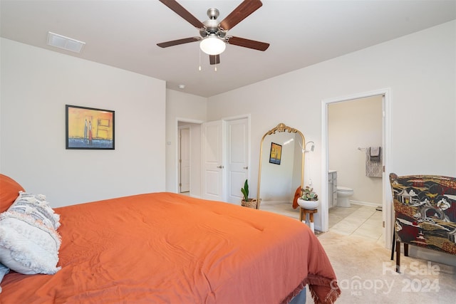 carpeted bedroom with ceiling fan and ensuite bathroom