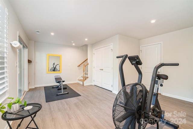 exercise area featuring light hardwood / wood-style floors