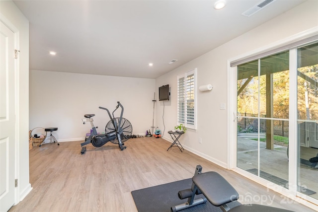 exercise area with light hardwood / wood-style floors