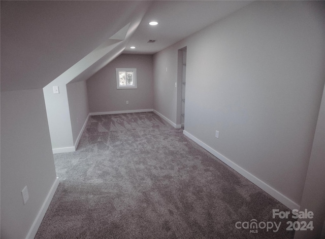 bonus room featuring carpet and vaulted ceiling