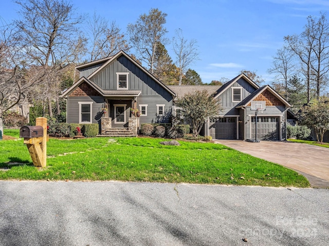 268 Firefly Cv, Lake Lure, NC 28746 - craftsman-style home with board and batten siding, an attached garage, driveway, and a front lawn