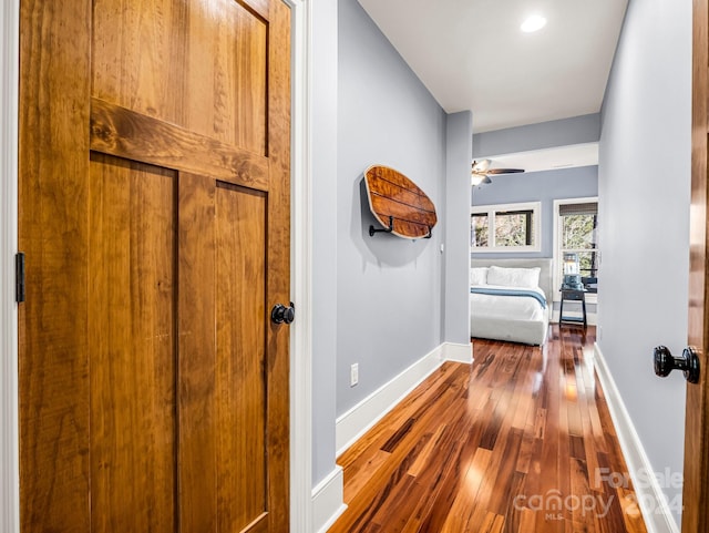 corridor with hardwood / wood-style flooring