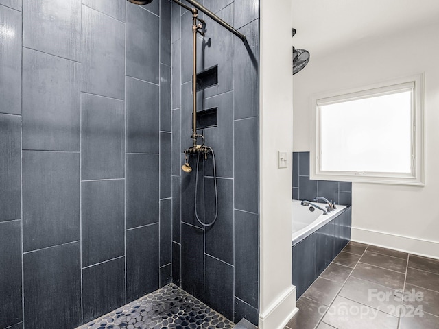 bathroom featuring tile patterned flooring and shower with separate bathtub