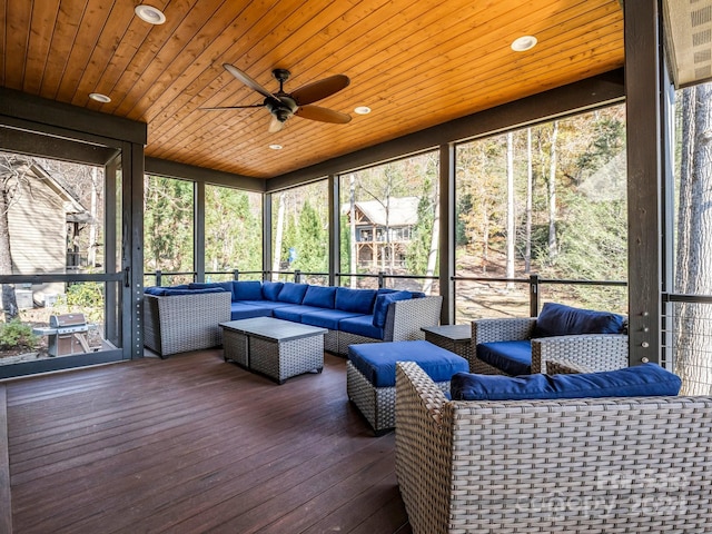 sunroom with ceiling fan and wood ceiling